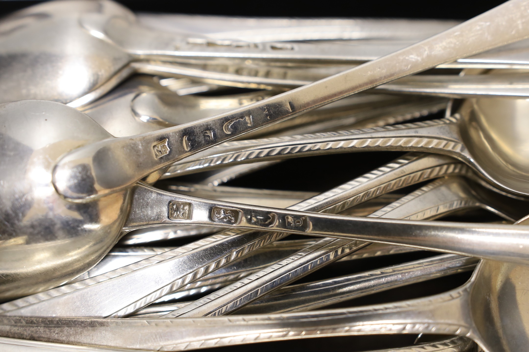 A matched harlequin set of thirty five late 18th/early 19th century silver Old English feather edge pattern table spoons, various dates and makers